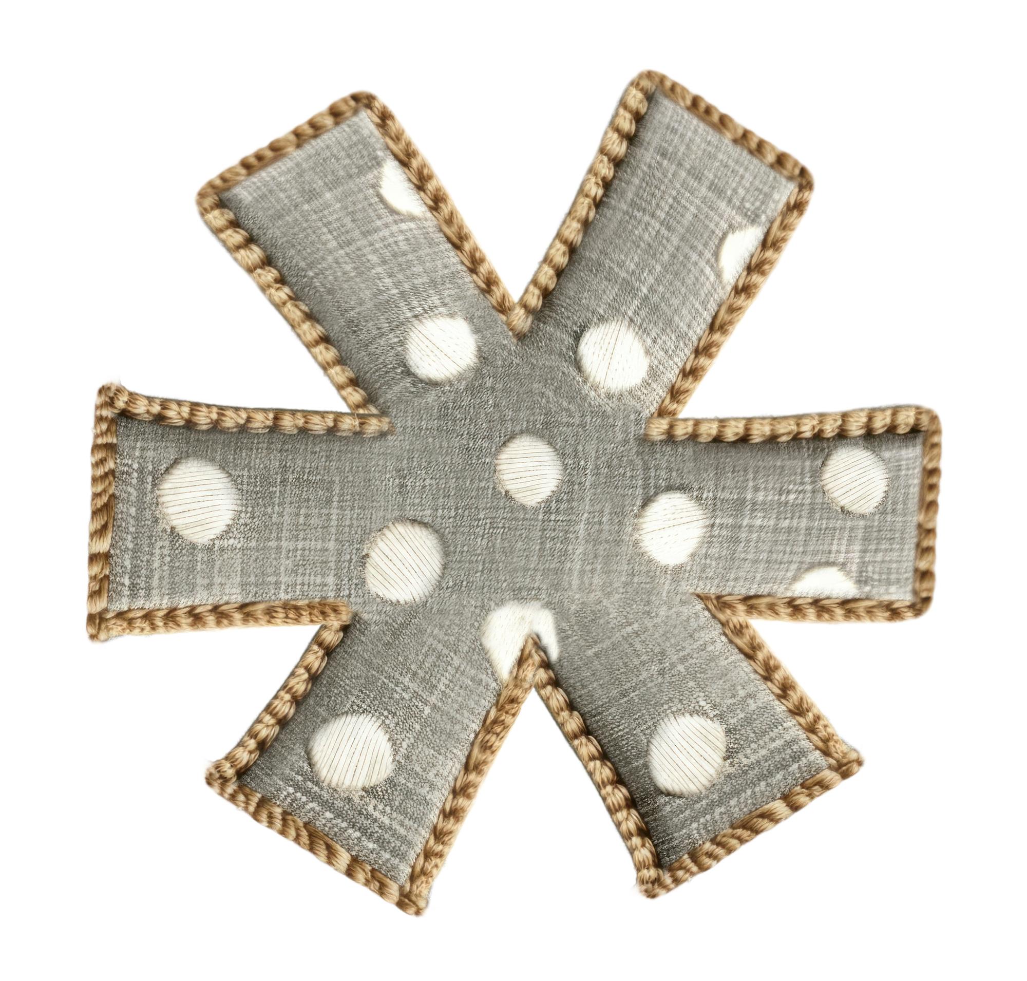 series of small embroidered pins displayed on board