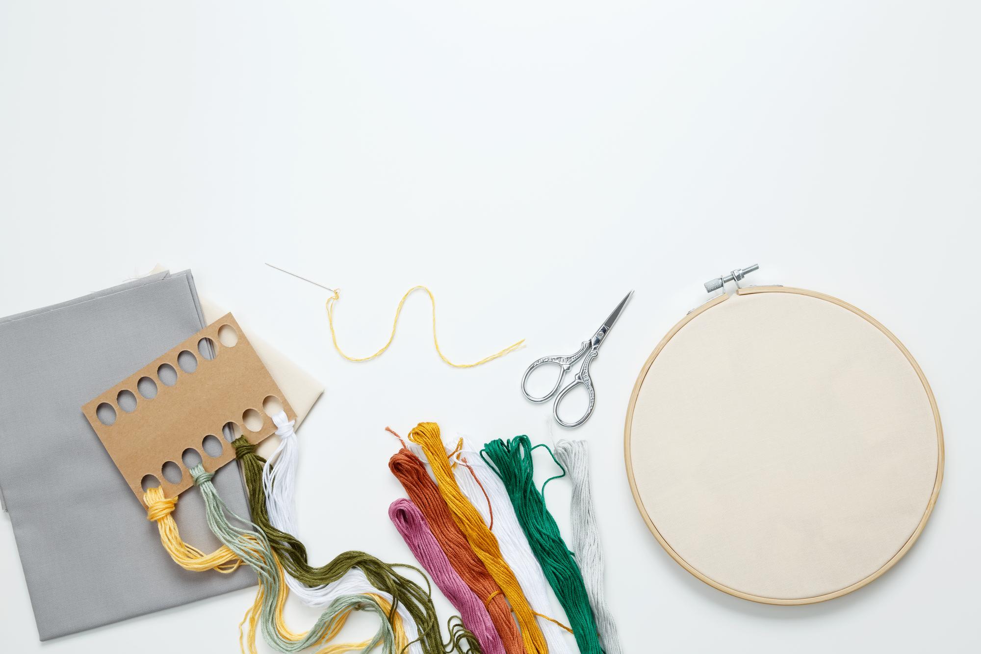 studio view with embroidery hoop and tools